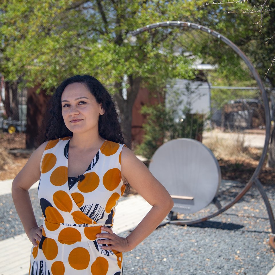 Pamela Martinez with a wind harp installation at Confluence Park