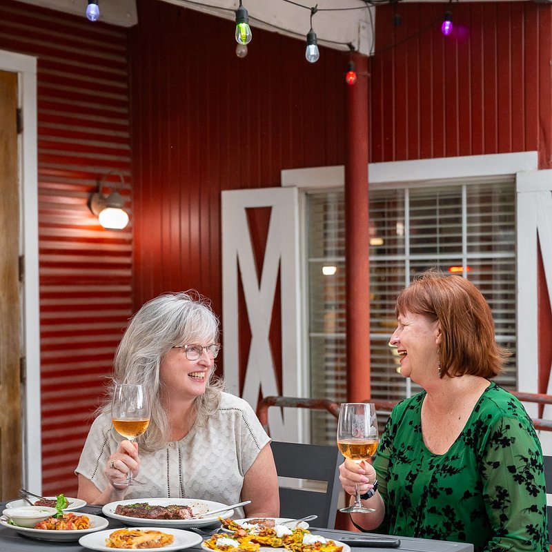 Smiling on Patio Cheers with Rose.jpg