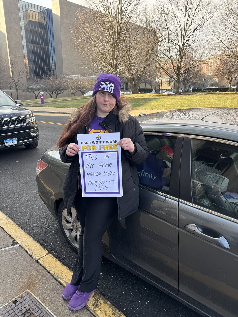 Kara O'Dwyer stands outside the car that she also calls home after being evicted.