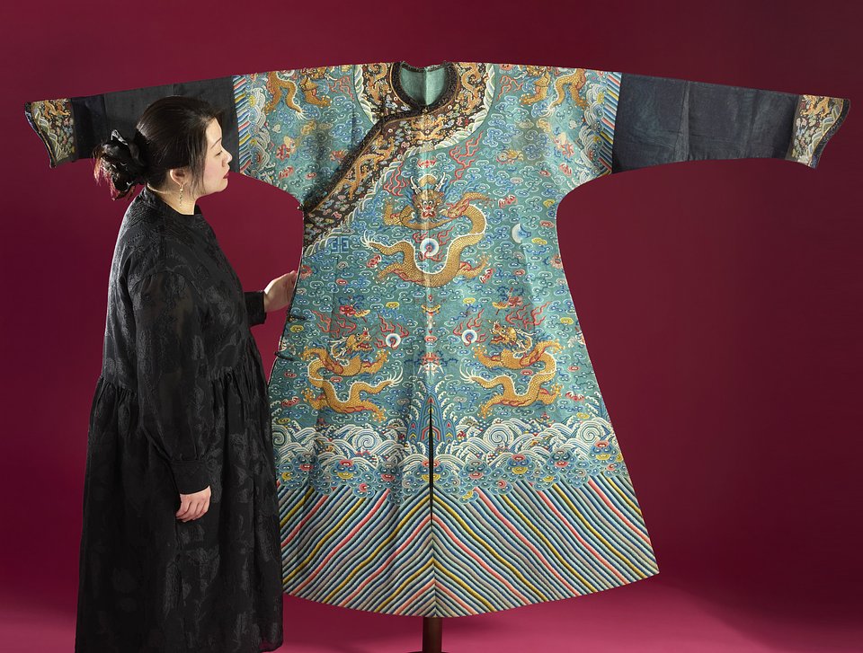 Roseberys Specialist Ruixue Li with an Imperial robe estimated to be worth £12,000