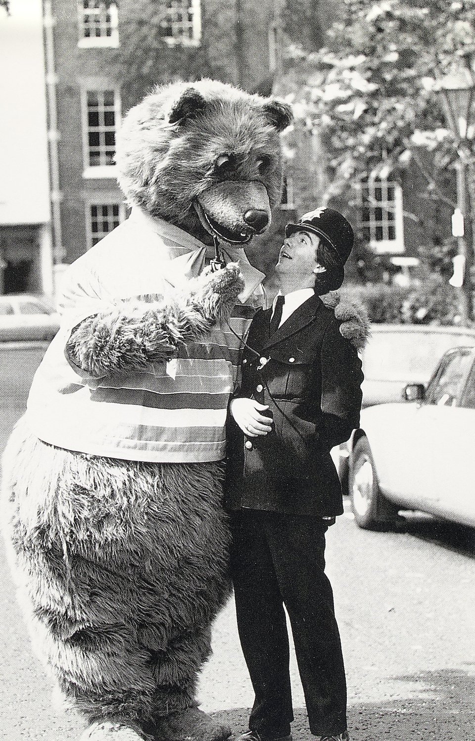 Stephen Marians poses for a photo with a policeman while operating the Bear. It is later republished as a postcard, which is included in the auction materials.