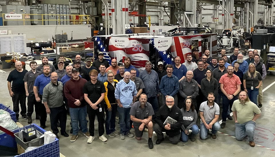 The Milacron team that worked on the first Patriotic M-Series 600 IMM platform at the corporate headquarters in Batavia, Ohio, is pictured here with American pride.