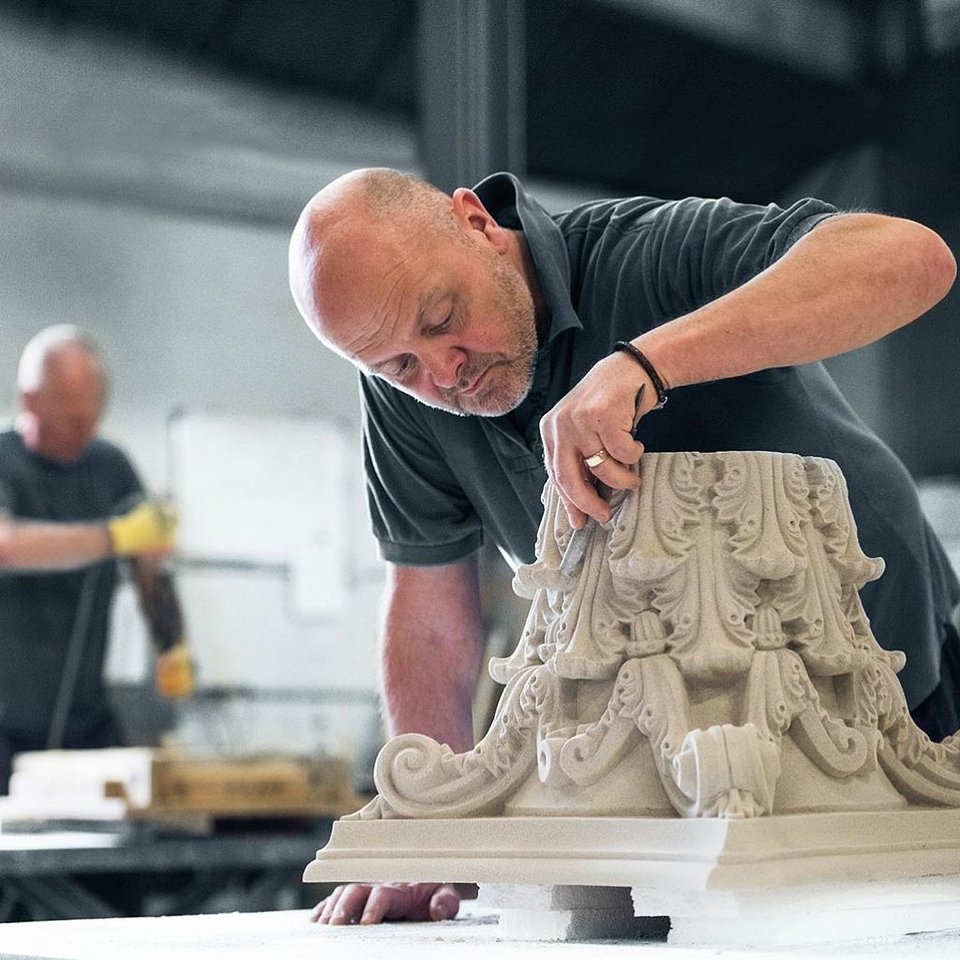 A Haddonstone craftsman works on an intricate design