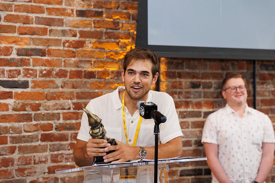 Sam Davis receiving the Academy Award®-qualifying Narrative Grand Prize for "The Singers" at the 2025 Indy Shorts Film Festival Awards Presentation. 