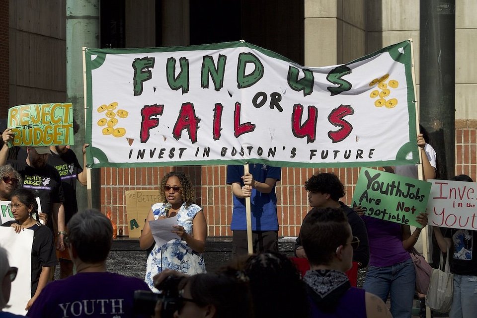Civic leaders rally outside Boston City Hall on May 26th, 2026, calling on city councilor's to reject the mayor's proposed budget cuts and restore funding for community needs. (Photo credit: T'Ajmal Hogue. Courtesy of Better Budget Alliance)
